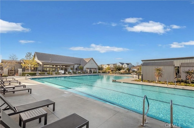 pool with a residential view and a patio area