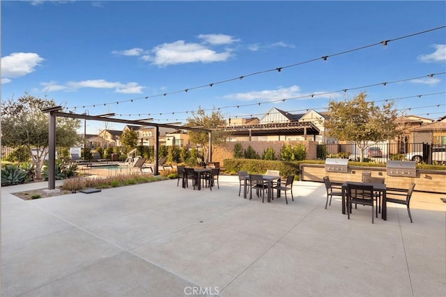 view of patio featuring a fenced in pool, exterior kitchen, outdoor dining area, grilling area, and fence