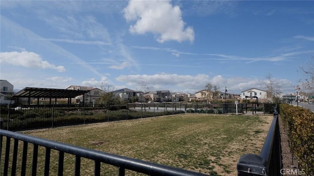 view of yard featuring fence and a residential view