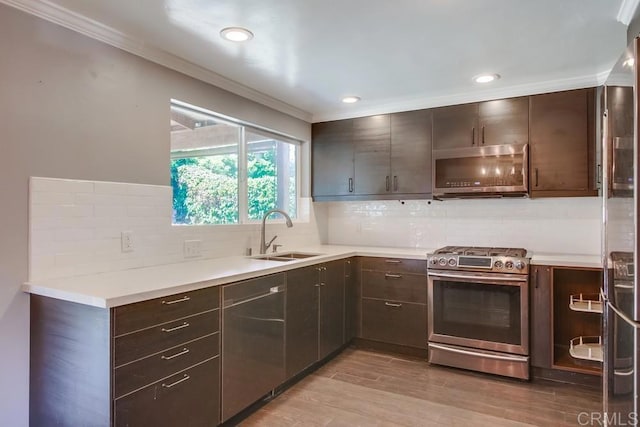 13522 Utopia Rd, Poway, CA 92064 - kitchen with stainless steel appliances, a sink, ornamental molding, dark brown cabinetry, and backsplash