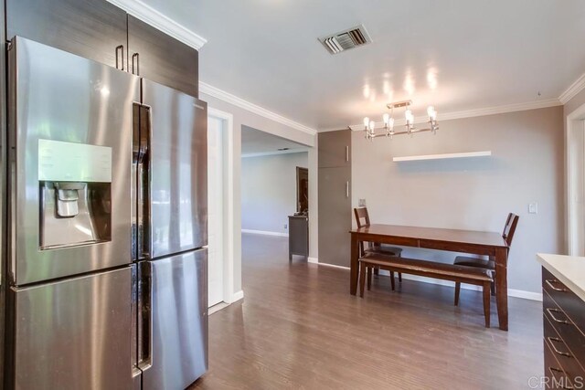 13522 Utopia Rd, Poway, CA 92064 - dining area with crown molding, dark wood finished floors, and a chandelier