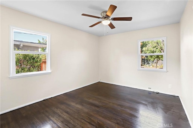 unfurnished room with baseboards, wood finished floors, and ceiling fan