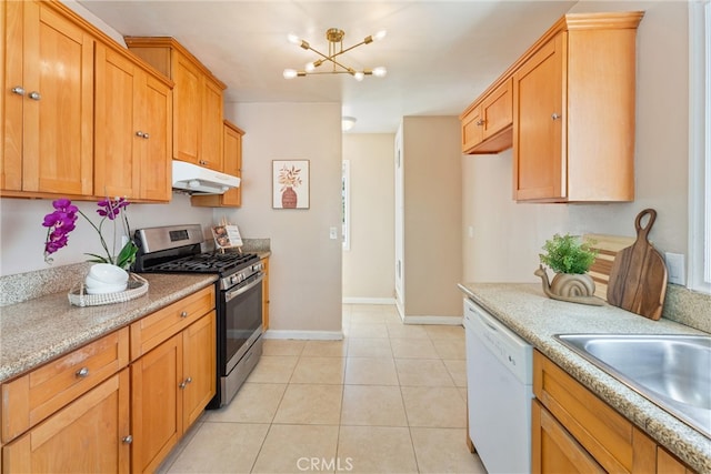 kitchen featuring white dishwasher, stainless steel gas range, a chandelier, baseboards, and under cabinet range hood