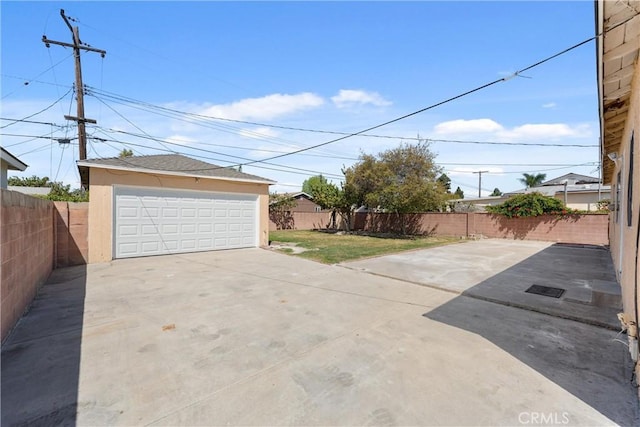 detached garage featuring fence