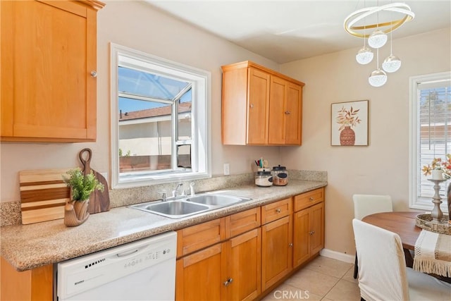 kitchen featuring dishwasher, light countertops, a sink, and light tile patterned floors