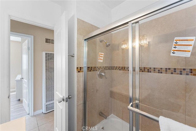 full bathroom with visible vents, tile patterned flooring, and a heating unit
