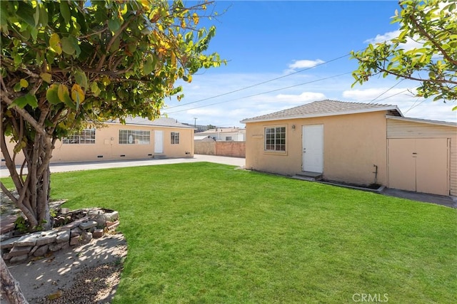 view of yard with fence and an outdoor structure