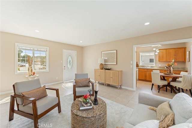 living area with baseboards, recessed lighting, and light tile patterned floors