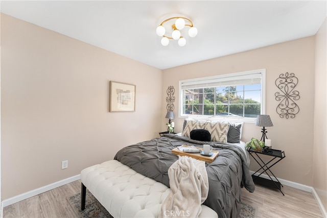 bedroom featuring baseboards and light wood-type flooring