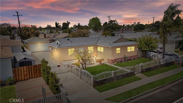 ranch-style home featuring a gate, a fenced front yard, driveway, a garage, and stucco siding