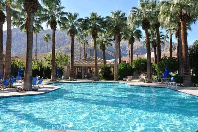 500 E Amado Rd Unit 420, Palm Springs, CA 92262 - community pool with a mountain view and a patio area