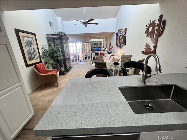 500 E Amado Rd Unit 420, Palm Springs, CA 92262 - kitchen with a sink, ceiling fan, light stone countertops, wood finished floors, and baseboards