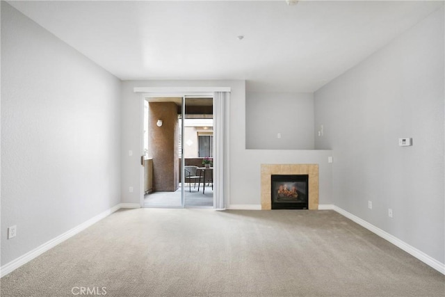 24909 Madison Ave Unit 1311, Murrieta, CA 92562 - unfurnished living room featuring carpet floors, baseboards, and a tile fireplace