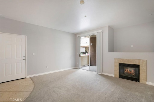 24909 Madison Ave Unit 1311, Murrieta, CA 92562 - unfurnished living room featuring baseboards, carpet, and a tile fireplace
