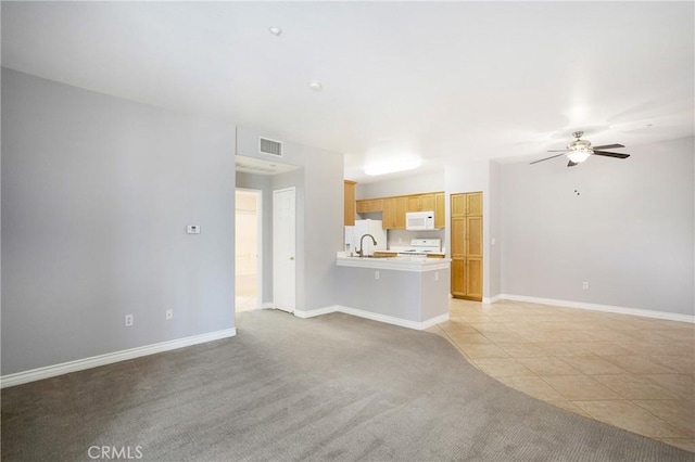 24909 Madison Ave Unit 1311, Murrieta, CA 92562 - unfurnished living room featuring light carpet, a ceiling fan, baseboards, light tile patterned floors, and visible vents
