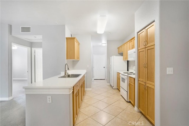 24909 Madison Ave Unit 1311, Murrieta, CA 92562 - kitchen featuring visible vents, a sink, light countertops, a peninsula, and white appliances