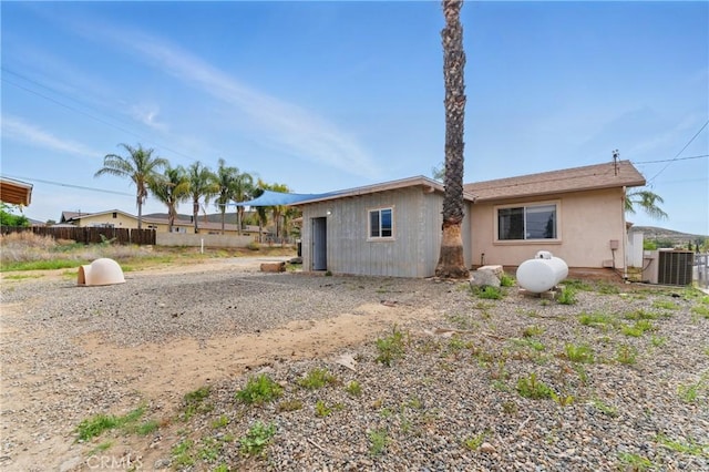 28755 Avenida Estrella, Menifee, CA 92587 - rear view of property featuring fence, stucco siding, and central AC