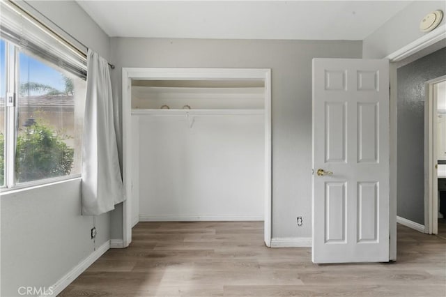 28755 Avenida Estrella, Menifee, CA 92587 - unfurnished bedroom with multiple windows, light wood-style flooring, and a closet