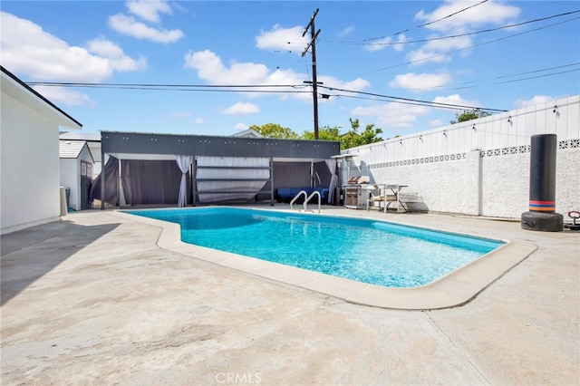 view of pool featuring a patio, a fenced backyard, and a fenced in pool