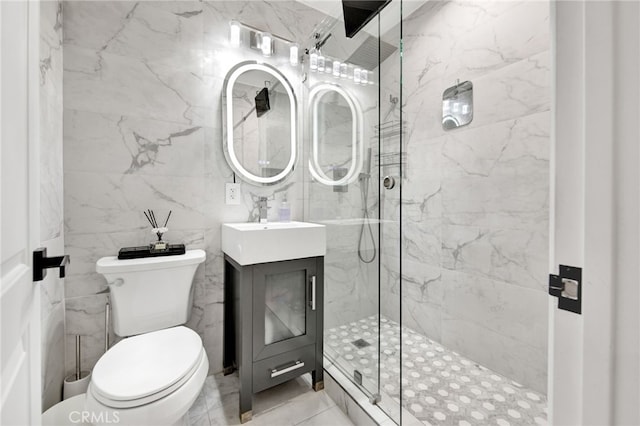 full bathroom featuring toilet, a marble finish shower, and vanity