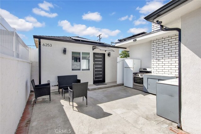 view of patio featuring exterior kitchen and a fenced backyard