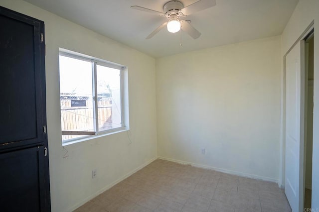 interior space with baseboards and ceiling fan