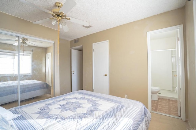bedroom with visible vents, a textured ceiling, a closet, and ceiling fan
