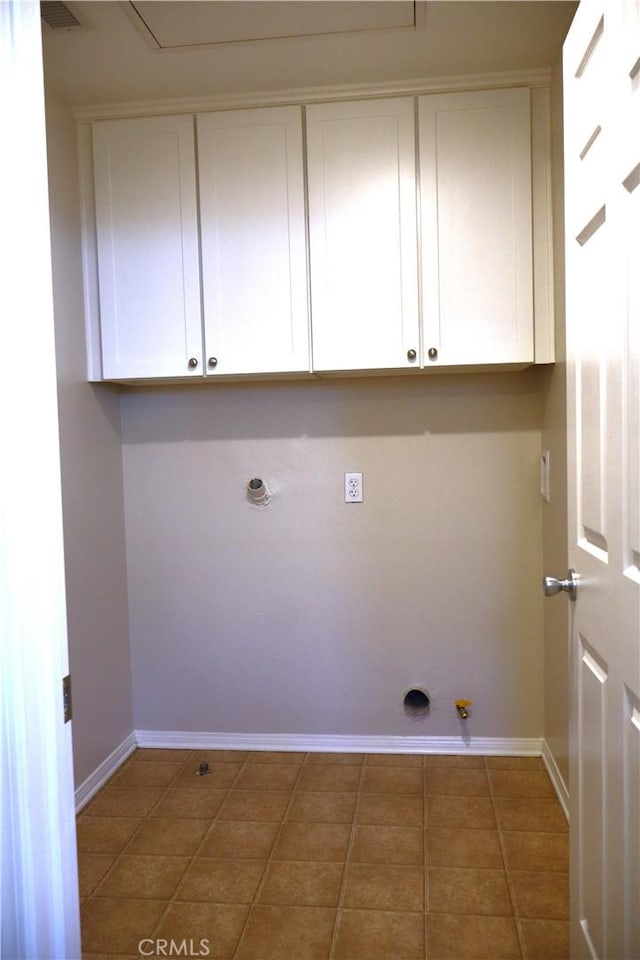washroom with hookup for an electric dryer, baseboards, cabinet space, and hookup for a gas dryer
