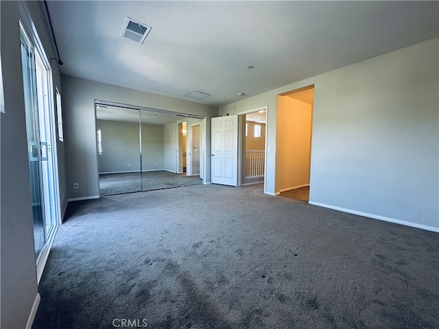unfurnished bedroom with baseboards, visible vents, a closet, and carpet flooring
