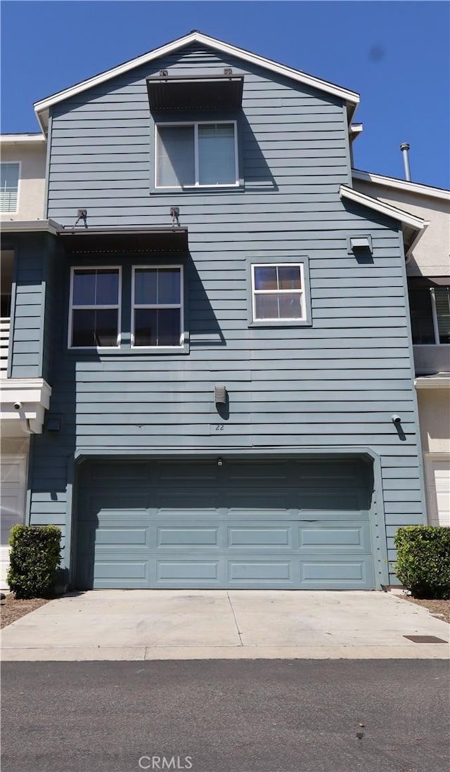 22 Platinum Cir, Ladera Ranch, CA 92694 - rear view of house featuring a garage and concrete driveway