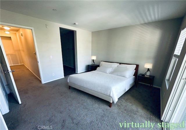 bedroom with a closet, dark colored carpet, and baseboards