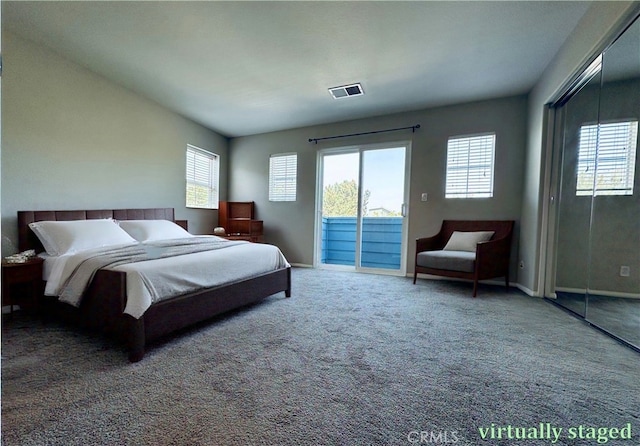 bedroom with access to exterior, visible vents, carpet, and baseboards