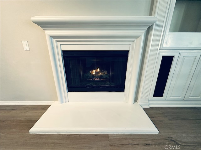 22 Platinum Cir, Ladera Ranch, CA 92694 - detailed view of wood finished floors, a warm lit fireplace, and baseboards