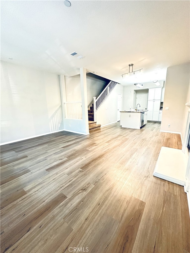 22 Platinum Cir, Ladera Ranch, CA 92694 - unfurnished living room featuring light wood finished floors, stairs, and baseboards