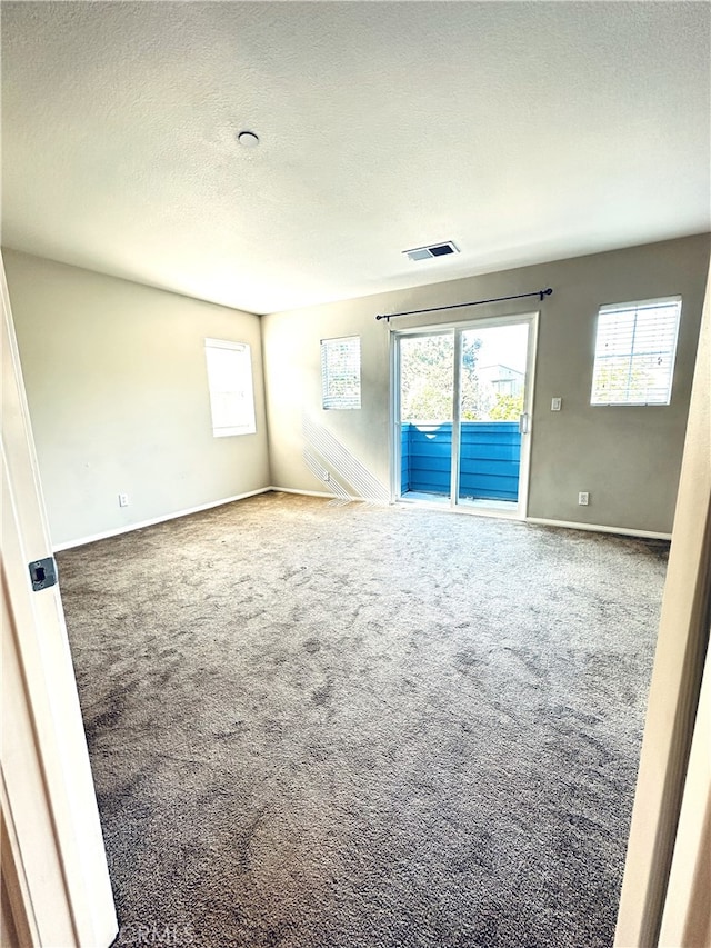 22 Platinum Cir, Ladera Ranch, CA 92694 - empty room with carpet flooring, a textured ceiling, plenty of natural light, and baseboards