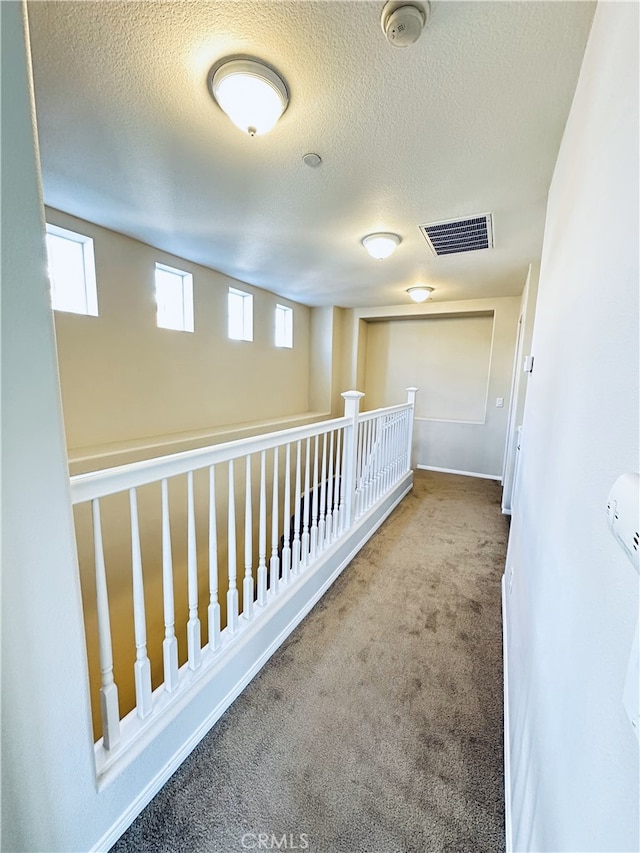 22 Platinum Cir, Ladera Ranch, CA 92694 - hall featuring carpet floors, plenty of natural light, a textured ceiling, and baseboards