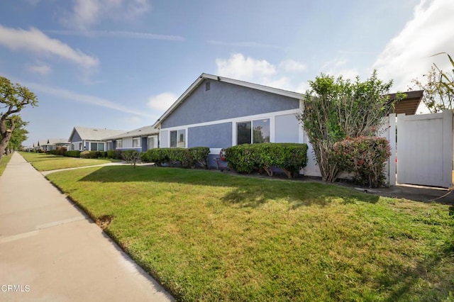 2430 Alexander St, Oxnard, CA 93033 - view of home's exterior featuring fence, stucco siding, and a yard