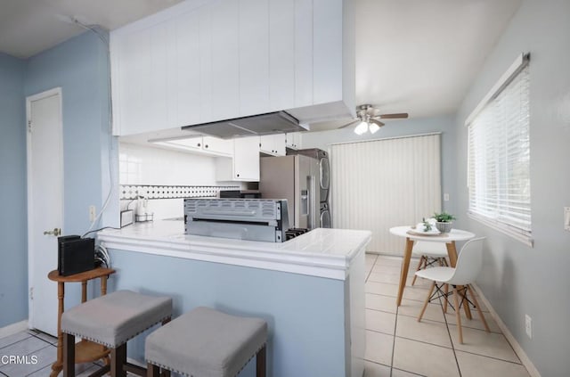 2430 Alexander St, Oxnard, CA 93033 - kitchen with stainless steel refrigerator with ice dispenser, a peninsula, light tile patterned floors, and ceiling fan