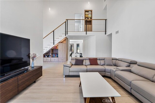 760 Featherwood Dr, Diamond Bar, CA 91765 - living area featuring a high ceiling, light wood-style flooring, and stairs