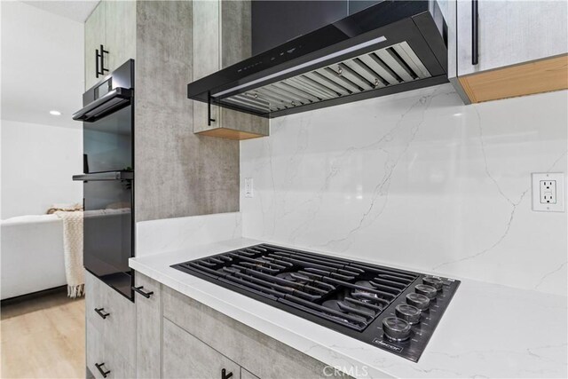 760 Featherwood Dr, Diamond Bar, CA 91765 - kitchen with extractor fan, black appliances, light stone countertops, tasteful backsplash, and light wood-style flooring