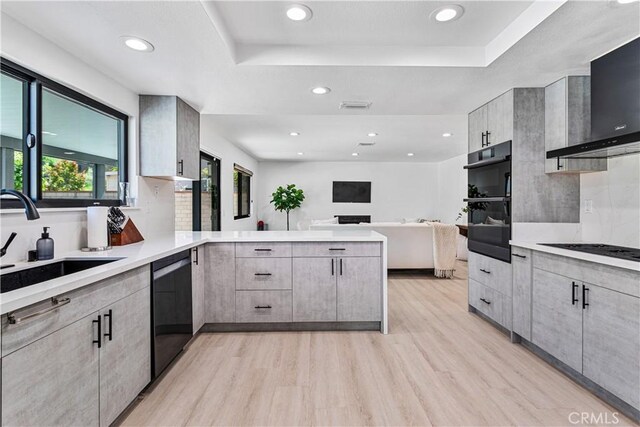 760 Featherwood Dr, Diamond Bar, CA 91765 - kitchen with black appliances, a peninsula, wall chimney range hood, light wood finished floors, and a sink