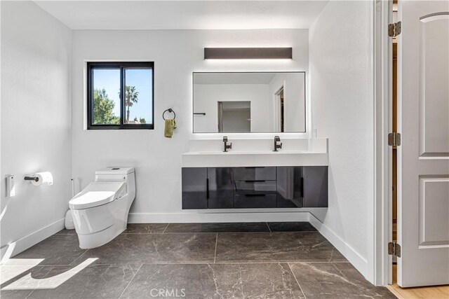 760 Featherwood Dr, Diamond Bar, CA 91765 - bathroom with baseboards, toilet, vanity, and marble finish flooring