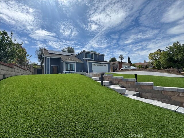 760 Featherwood Dr, Diamond Bar, CA 91765 - view of front of house with roof mounted solar panels and a garage