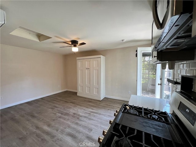 10709 Wheelock Cir, Whittier, CA 90606 - kitchen with baseboards, a ceiling fan, wood finished floors, and gas range oven