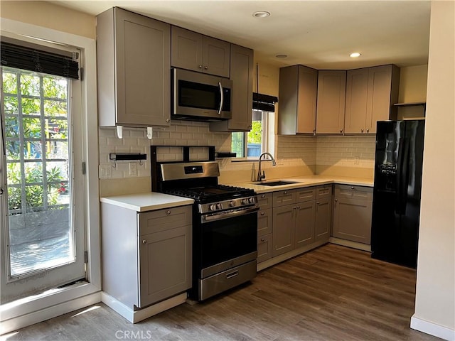 10709 Wheelock Cir, Whittier, CA 90606 - kitchen featuring a sink, light countertops, gray cabinets, stainless steel appliances, and dark wood-style floors