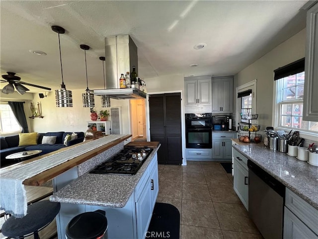 10709 Wheelock Cir, Whittier, CA 90606 - kitchen featuring a ceiling fan, open floor plan, island range hood, dark tile patterned flooring, and black appliances
