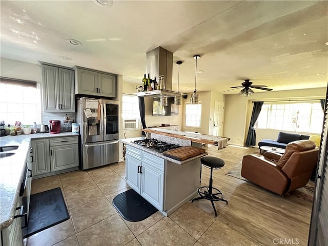 10709 Wheelock Cir, Whittier, CA 90606 - kitchen featuring open floor plan, a kitchen bar, gray cabinetry, and stainless steel appliances