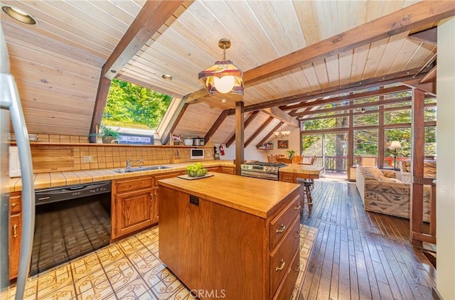 1163 Silvertip Ln, Fish Camp, CA 93623 - kitchen featuring black dishwasher, wooden ceiling, vaulted ceiling with skylight, and butcher block counters