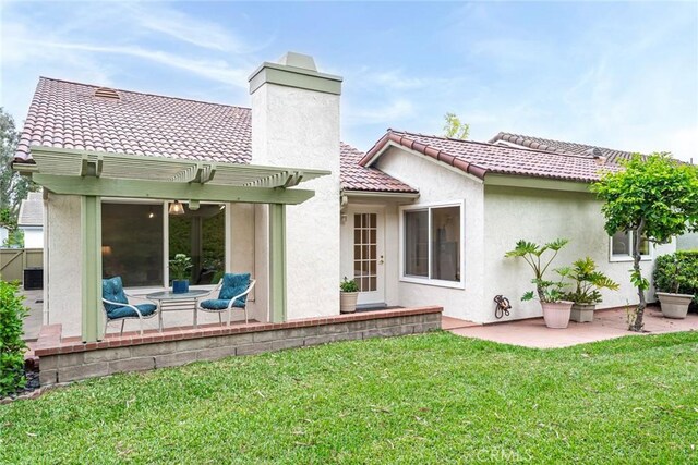 28143 Espinoza, Mission Viejo, CA 92692 - back of property with a lawn, a pergola, a chimney, and a patio