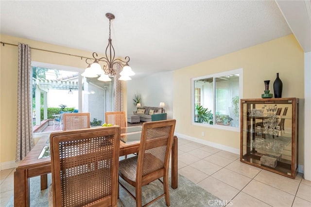 28143 Espinoza, Mission Viejo, CA 92692 - dining room with light tile patterned floors, baseboards, and a chandelier